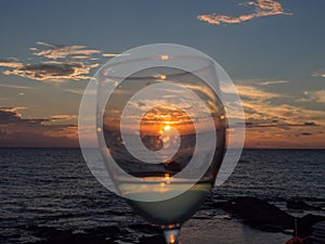 Sea and glass of wine at sunset. Pantelleria, Sicily, Italy