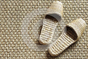 Sea-grass slippers on woven carpet