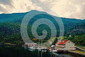 Sea harbor on mountain landscape in Flam, Norway. Yachts and sailboats at sea port. Adventure and discovery. Wanderlust