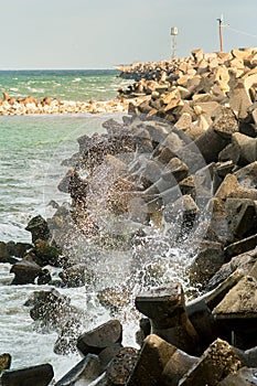 Sea hitting a stone dam