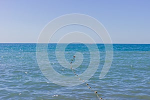 Sea horison and Plastic buoys marking a restricted area on the water