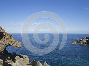 Sea horizon with sharp rocks and cliffs in forward, creal blue s
