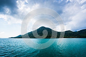 Sea and island on blue sky with cloud background