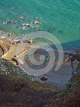 Sea kayaks on the beach in Ireland, sun and sea, a tiny hidden beach