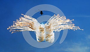 Sea King Mk4 `junglie` helicopter of the Royal Navy Fleet Air Arm fires a salvo of flares