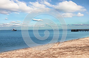 Sea landscape with boat and jetty bridge