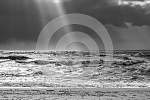 Sea landscape with huge waves and a lightbeam in Sylt