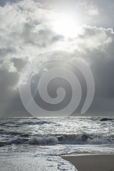 Sea landscape with huge waves and a lightbeam in Sylt photo