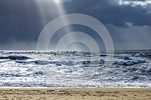 Sea landscape with huge waves and a lightbeam in Sylt photo