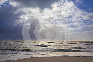 Sea landscape with huge waves and a lightbeam in Sylt photo