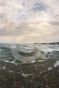 Sea landscape with pebble and pier