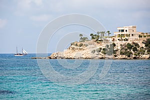 Sea landscape with sailboat and villa