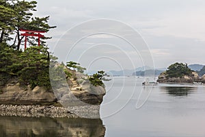 Sea landscape with several islets and a red torii gate in Matsushima, Japan. photo