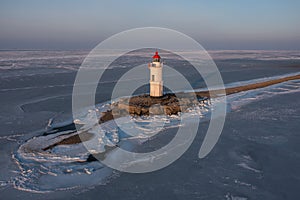 Sea Lighthouse on the Tokarevskaya Koshka rock spit, in winter.