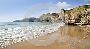 Sea meets sand reflecting the towering Pembroke Coastline between Lydstep and Manorbier Bay