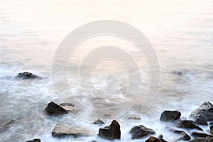 Sea mist softness of the tides and sunset at evening with rocks