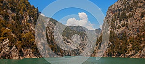 Sea and mountain against beautiful blue sky. Horizontal panorama