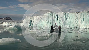 Sea mountains and large icebergs reflecting water.