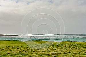 Sea next to Skara Brae prehistoric village at Orkney Island, Scotland, wide angle shot