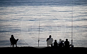 Sea/Ocean fishing - fishermen sitting by the sea