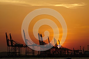 Sea oil drilling platform, sunset