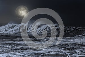 Sea in an overcast full moon night
