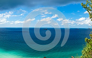 Sea panorama with cargo container ships.  Blue sky with clouds.