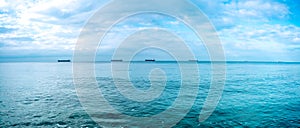 Sea panorama with cargo ships and sky