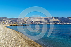 Sea pebble against the backdrop of the blue sea at sunset on beach and under water of Black Sea coast