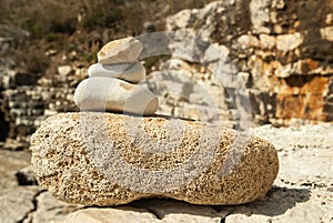 Sea pebble pyramid tower on seacoast. Stone Tower