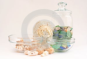 Sea pebbles and shells in glass containers