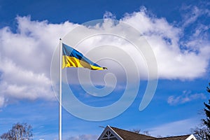 Sea pennant in Swedish flag colors on blue sky background. 6 June. Flag of Sweden waving high on the flagpole.