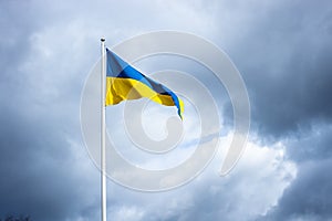 Sea pennant in Swedish flag colors on cloudy dramatic sky background. 6 June. Flag of Sweden waving high on the flagpole.