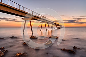 The sea pier of Badalona before sunrise