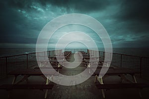 Sea pier and cold dramatic cloudscape