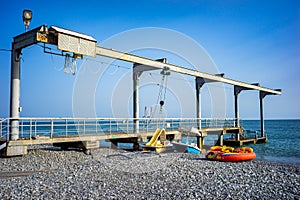 Sea pier with crane lifts water bike