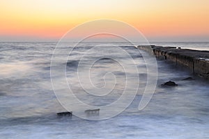 Sea and pier at dawn, calm