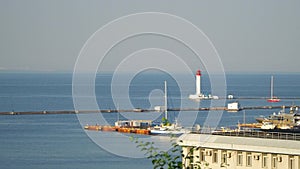 Sea pier. see the lighthouse, the yacht at the pier, sailed yacht.