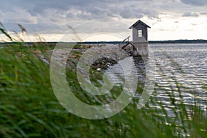 Sea pier with a small wooden house next to it