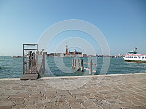 Sea pier in Venice opposite the island of San Michele. Venice, Italy. August 2012