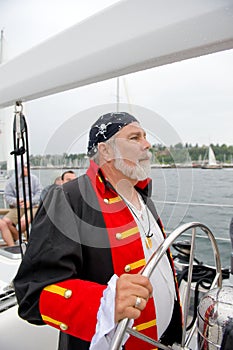 Sea pirate at sailboat helm