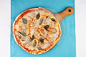 Sea Pizza from assorted fish, Colmar rings, greens and tomato sauce