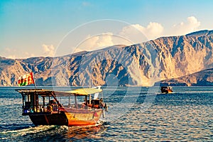 Sea, pleasure boats, rocky shores in the fjords of the Gulf of Oman