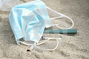 Sea pollution garbage,cotton swabs,razor blade and cigarettes discarded on beach