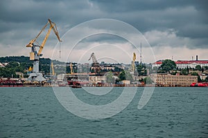 Sea port with cargo cranes and dry dock for ship repair