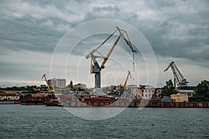 Sea port with cargo cranes and dry dock for ship repair