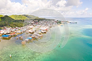 Sea port in the city of Dapa, Philippines. Fishing village and ships, view from above.