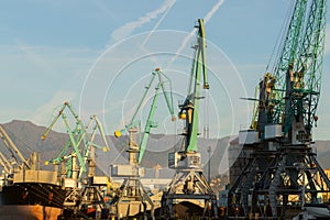 Sea port logistic, cranes for loading onto ships in the seaport, dry-cargo ship