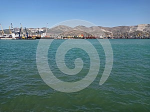 Sea port. mountain range. marin industrial cranes in the sea port.