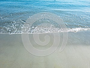 Sea ripple water on wet sand. Empty sandy beach, Greek island Cyclades, Greece. Space, top view